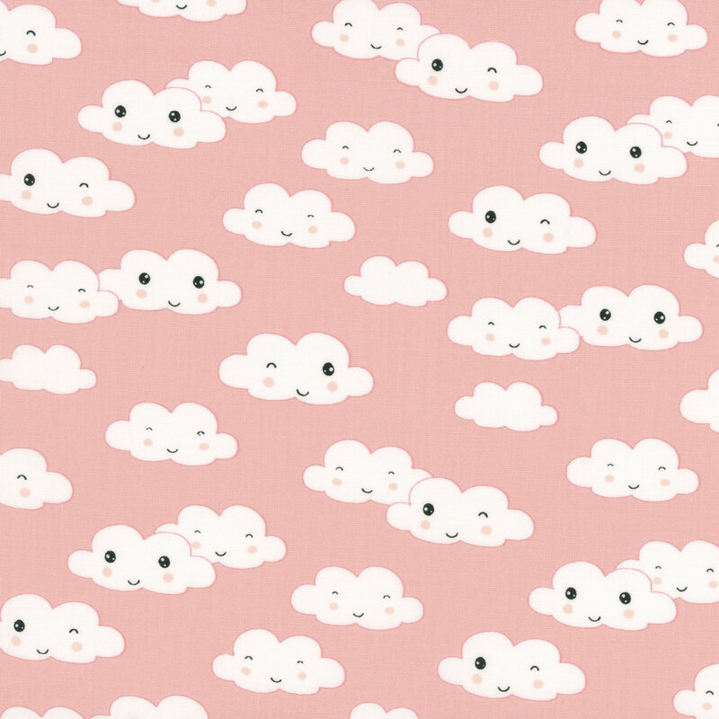 A salmon pink fabric with tossed white clouds with cute smiling and winking faces.
