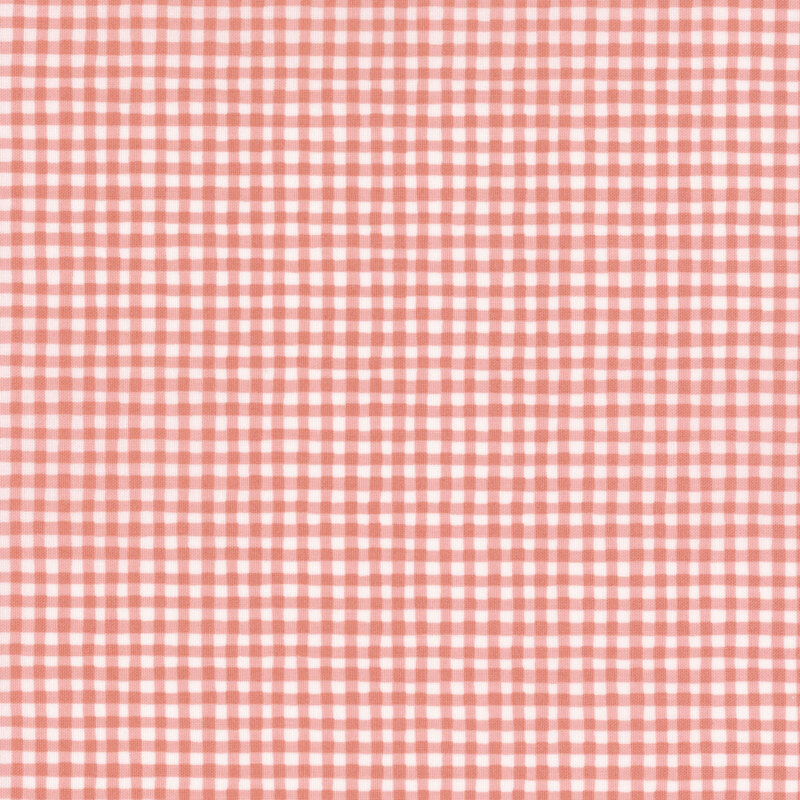 A white and peachy pink gingham fabric.