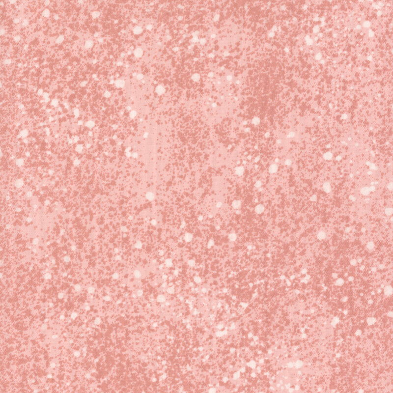 A peachy pink fabric with subtle mottling and a white spray effect.