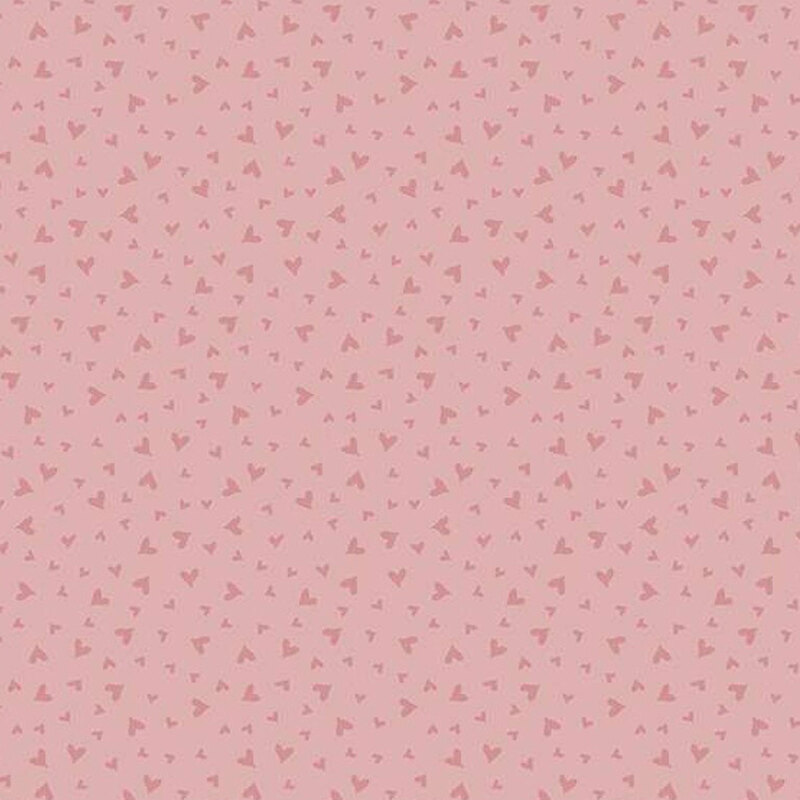 fabric pattern of dark pink hearts on a burnt pink background