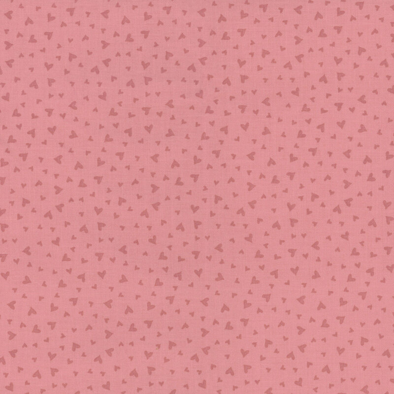fabric pattern of dark pink hearts on a burnt pink background