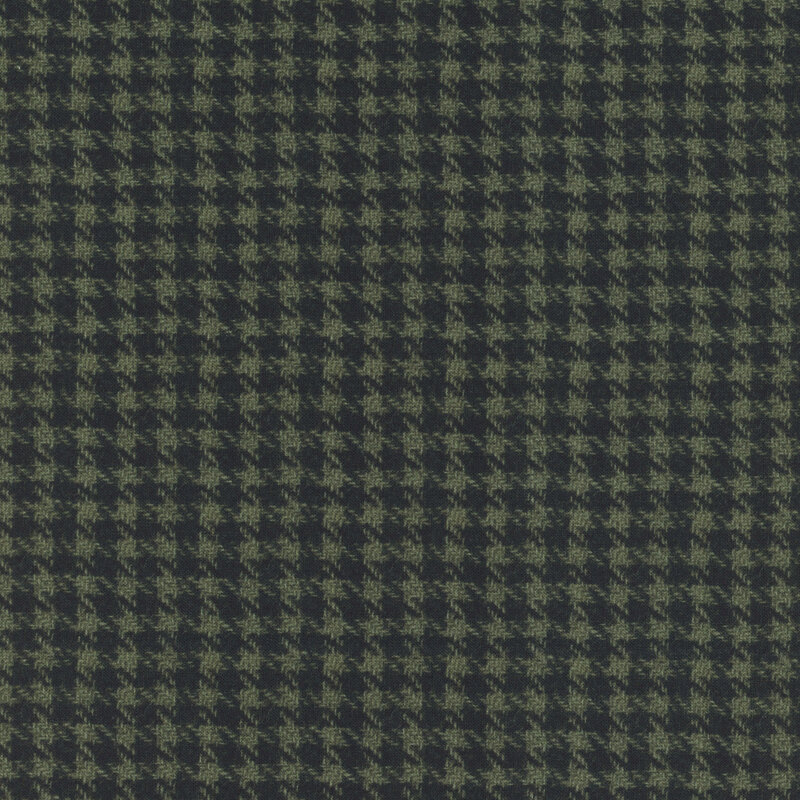 Dark green houndstooth patterned fabric with varying shades creating a textured appearance.