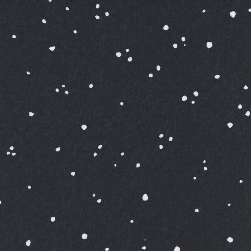 A dark blue fabric background with scattered white speckles resembling snow..