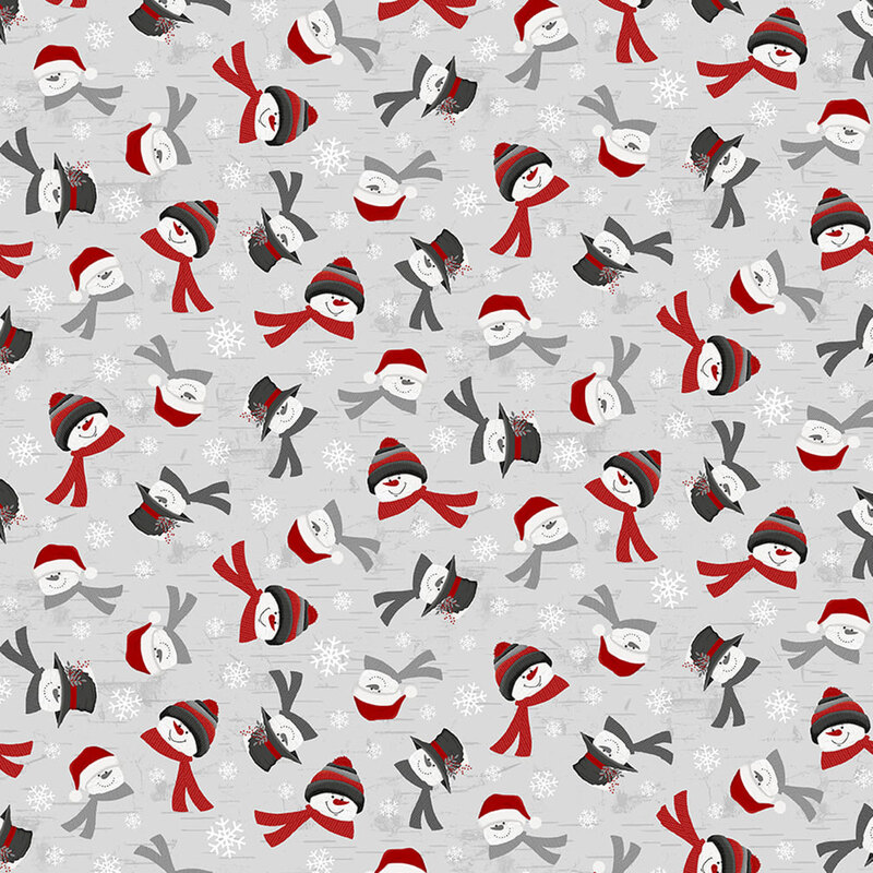 Gray fabric with tossed snowflakes and snowmen fitted in winter wear on a textured background.