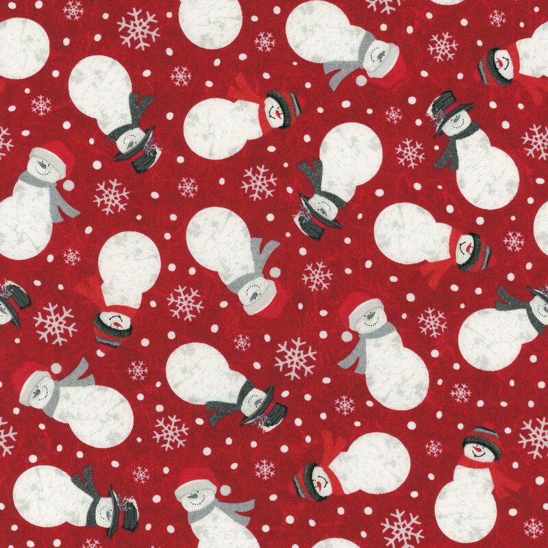 Maroon fabric with tossed snowflakes and snowmen dressed in winter wear on a tonal frost background.