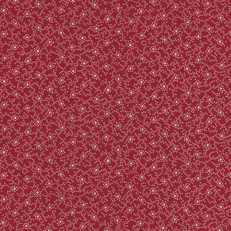 Red fabric with a repeating abstract white texture pattern.