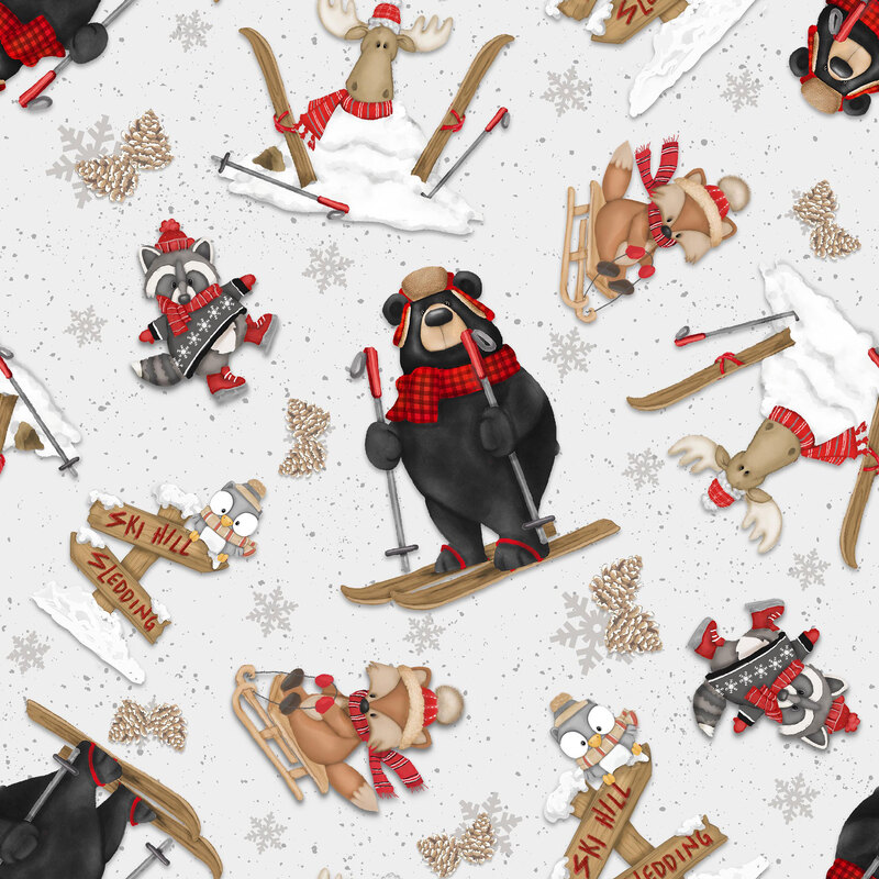 Light gray fabric with tossed woodland animals sledding, ice skating, and skiing on a snowflake-strewn background.