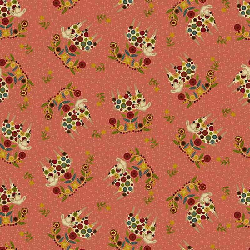 decorative fabric pattern of sheep, stars, and motifs on a burnt pink background. 