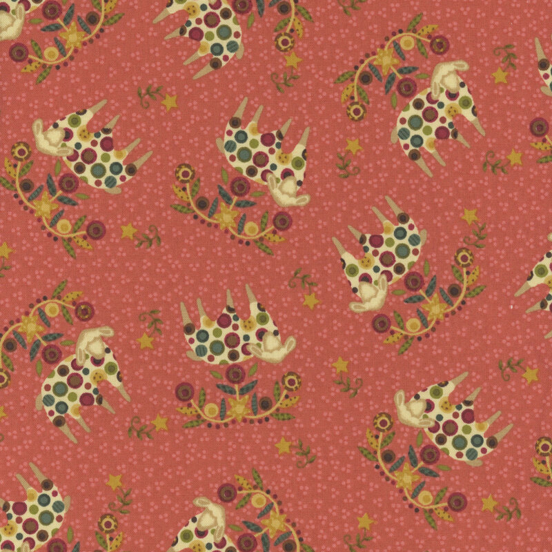decorative fabric pattern of sheep, stars, and motifs on a burnt pink background. 