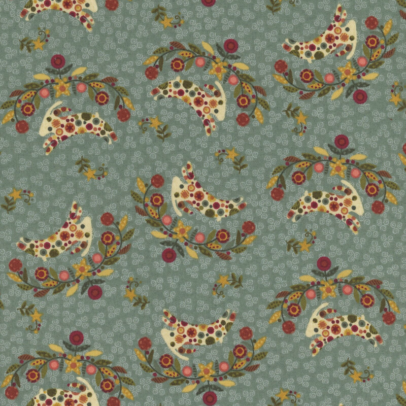 decorative fabric pattern of rams, stars, and motifs on a deep teal background. 