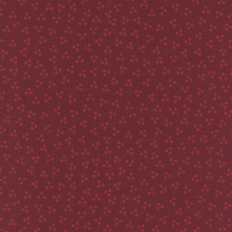 ditsy pattern of small tonal motifs on a red background