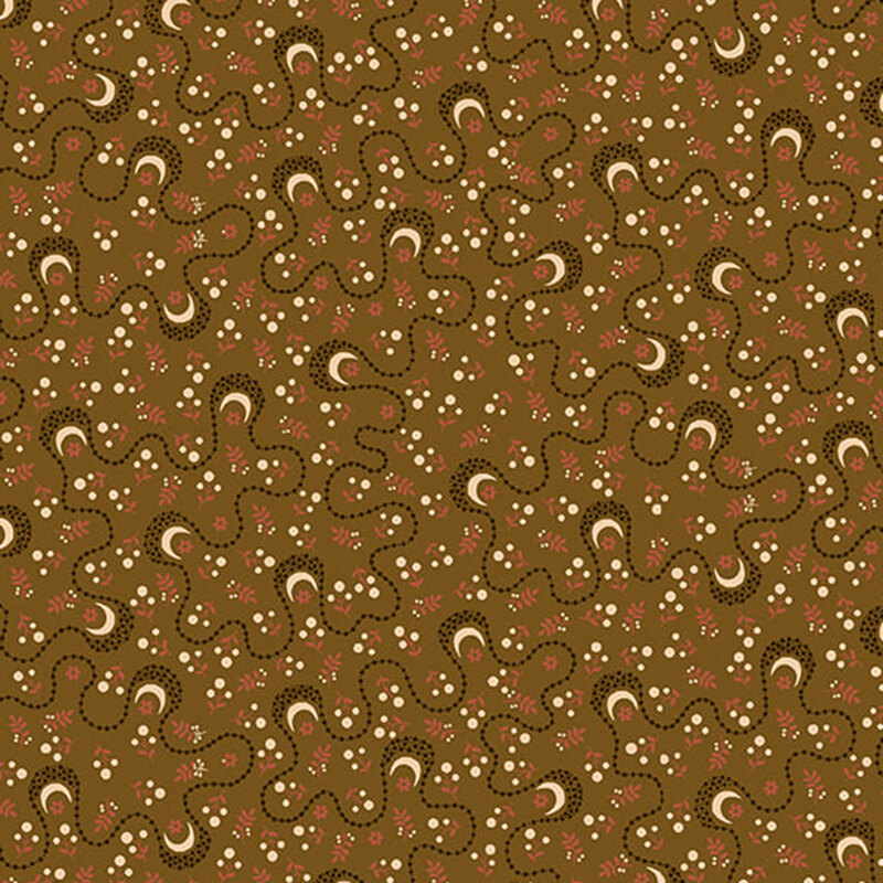 whimsical fabric pattern of moons and other floral motifs on a brown background