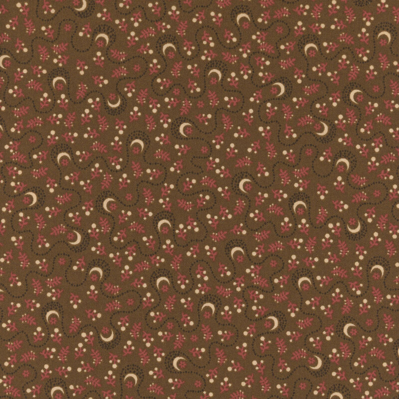 whimsical fabric pattern of moons and other floral motifs on a brown background