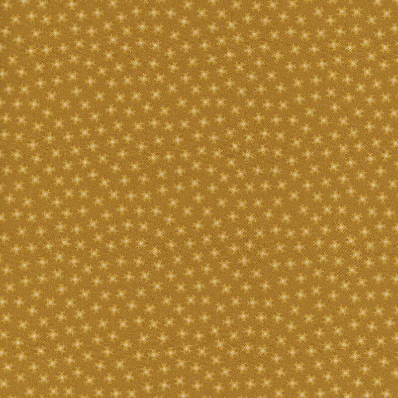 a fabric pattern of small motifs on a burnt yellow background