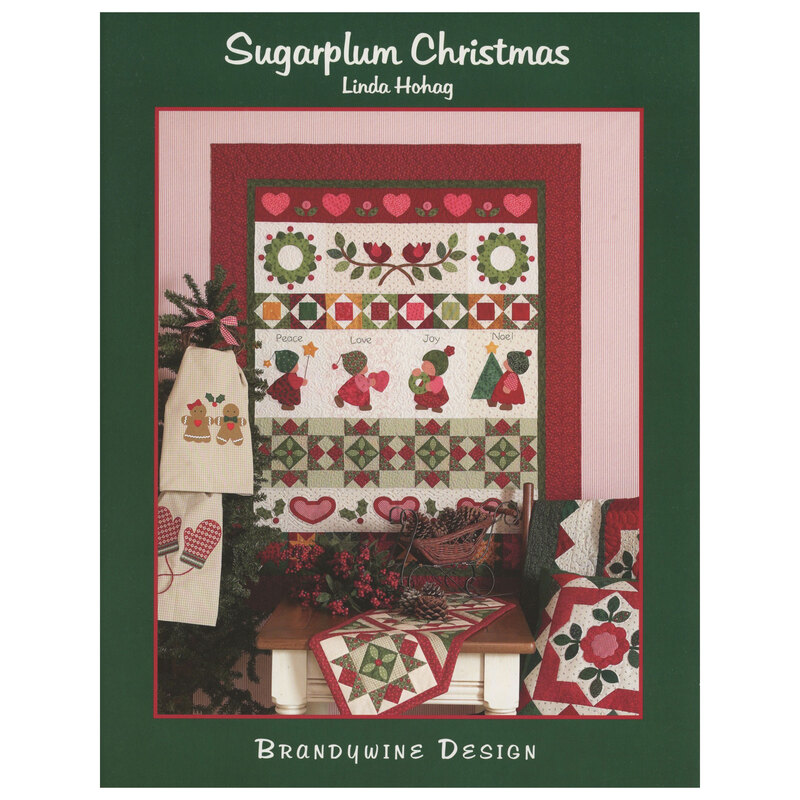 The front of the Sugarplum Christmas book, with all of the finished projects displayed on the wall and draped over furniture.