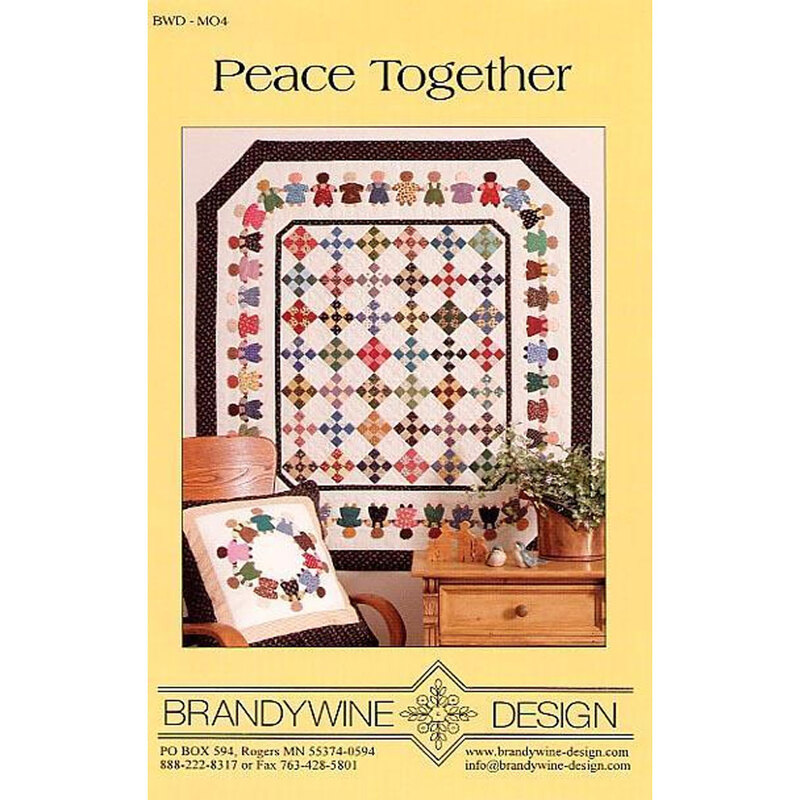 A quilt design featuring colorful teddy bear motifs framed by a diamond pattern, displayed beside a chair.