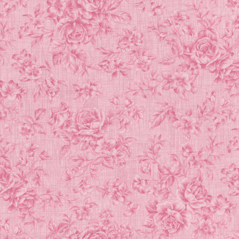 Tonal floral fabric pattern with a pink background, featuring roses and various small flowers.