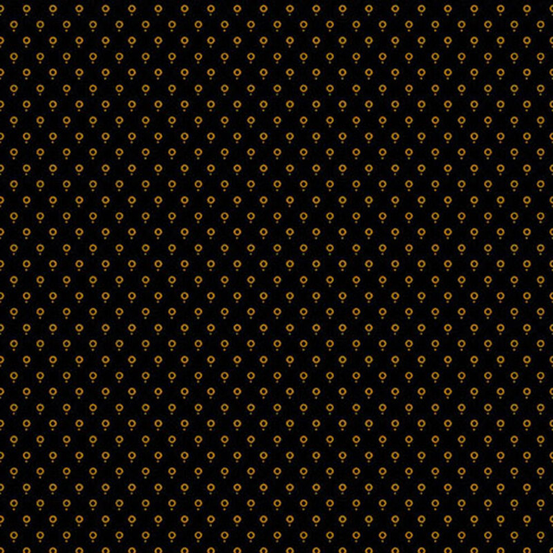 fabric pattern of golden dots on a black background