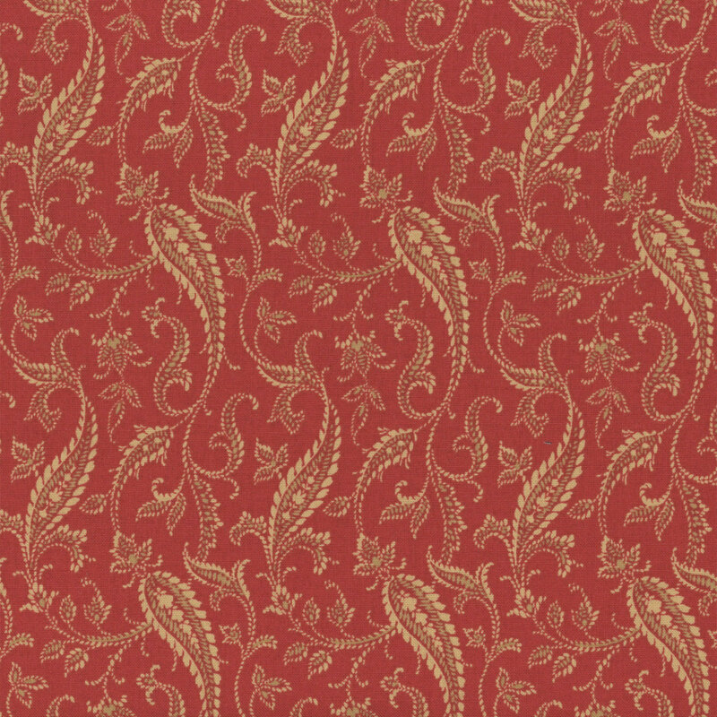fabric pattern of a tan paisley on a red background