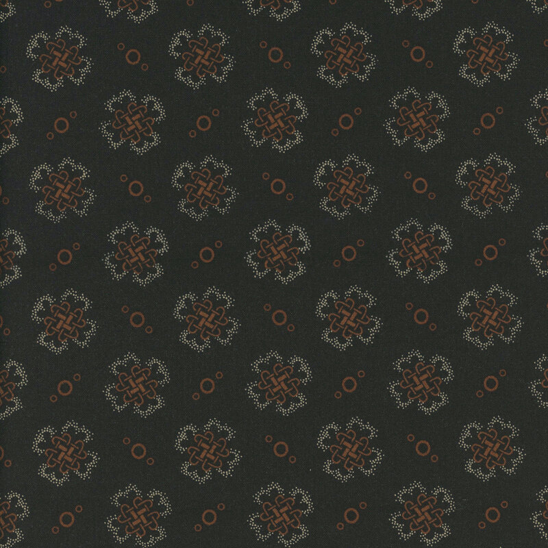 fabric pattern of golden threads of knots and circles on a black background