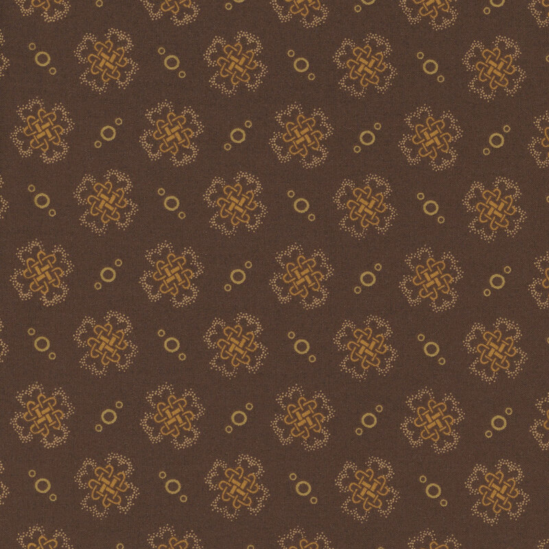 fabric pattern of golden threads of knots and circles on a brown background