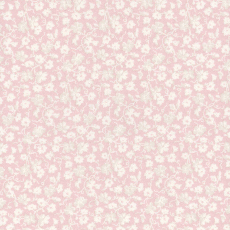 Pastel pink fabric with a white pattern of florals and swirling vines.