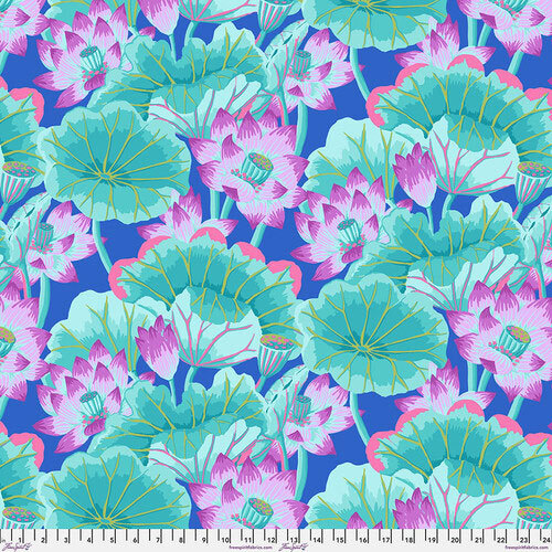 A vibrant pattern of pink and purple lotus flowers and green lily pads against a blue fabric.