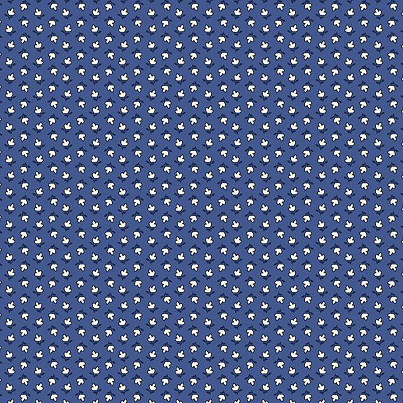 fabric pattern of white floral motifs on a blue background