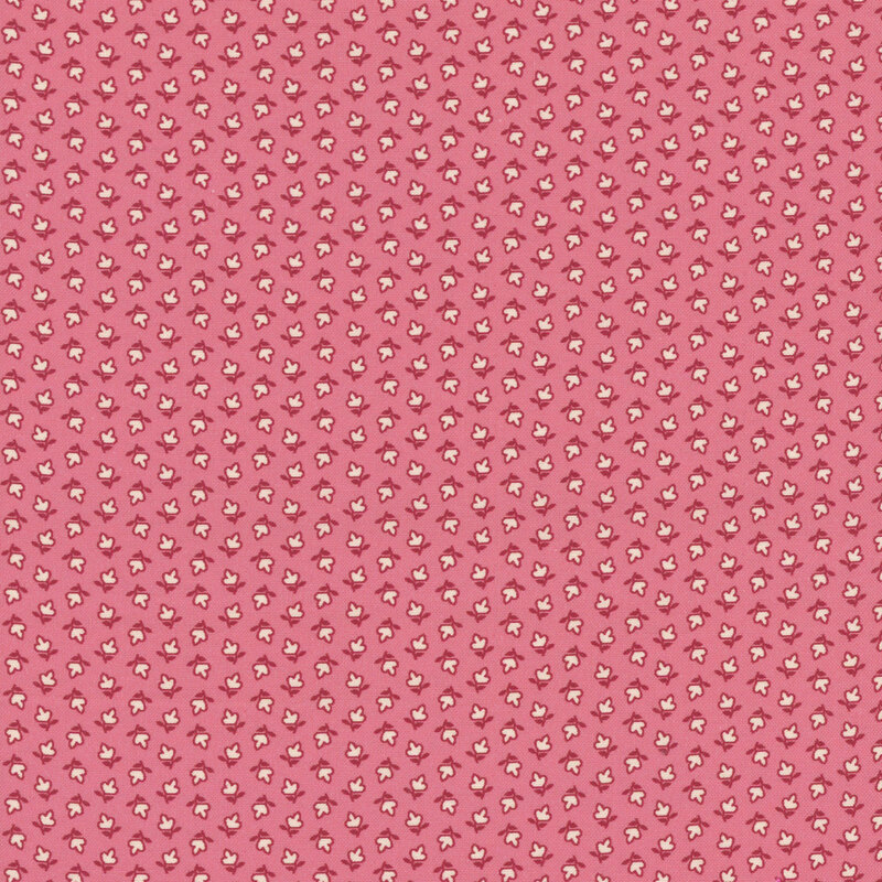 fabric pattern of white floral motifs on a pink background