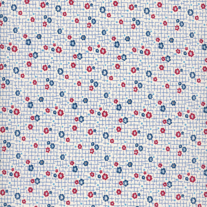 fabric pattern of blue and red floral motifs on a cream background with light blue stitches 