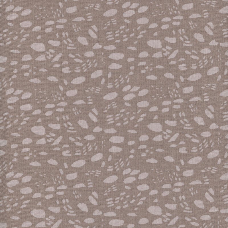 Tonal brown abstract fabric pattern with irregular shapes and textures arranged to mimic animal footprints.