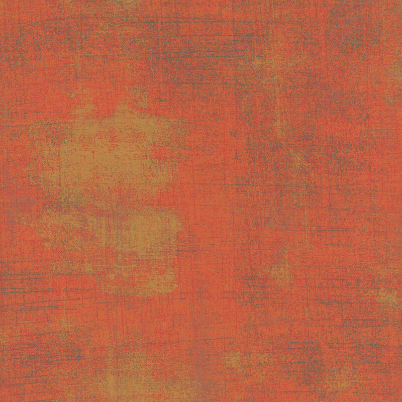 Textured abstract fabric in warm shades of orange and rust with subtle variations.