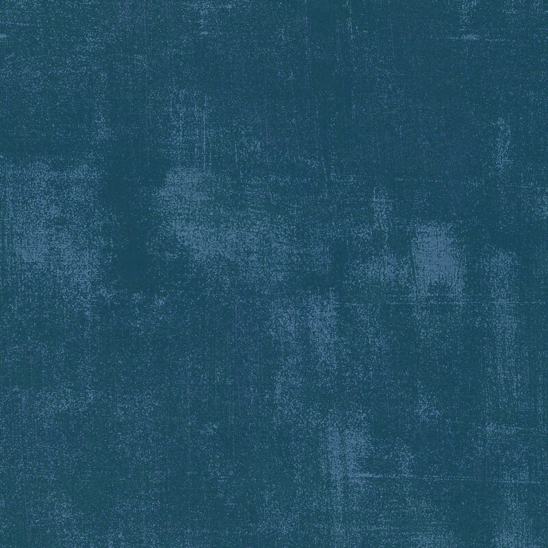 Textured fabric in shades of deep blue with a subtle gradient and uneven coloration.