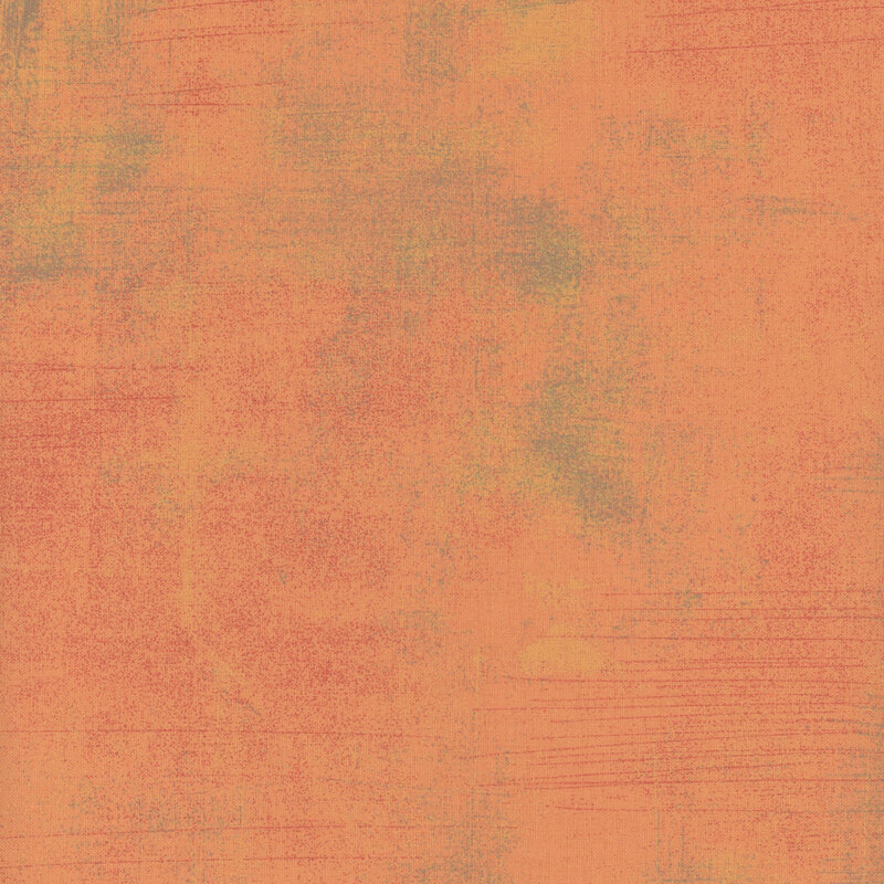 Textured fabric in warm orange tones with subtle variations and a painterly appearance.