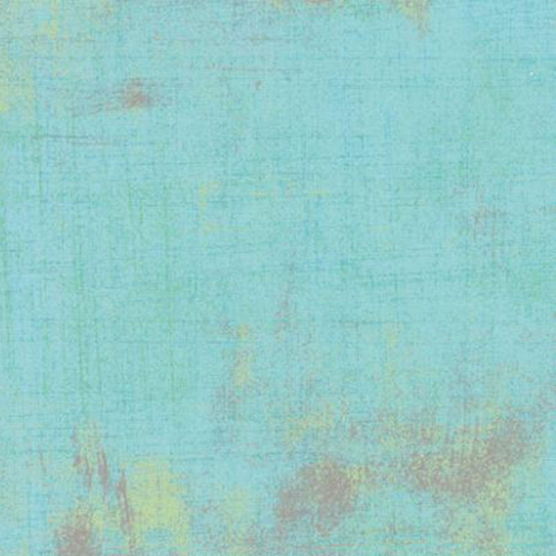 A textured fabric in soft turquoise with subtle variations and earthy brown accents.