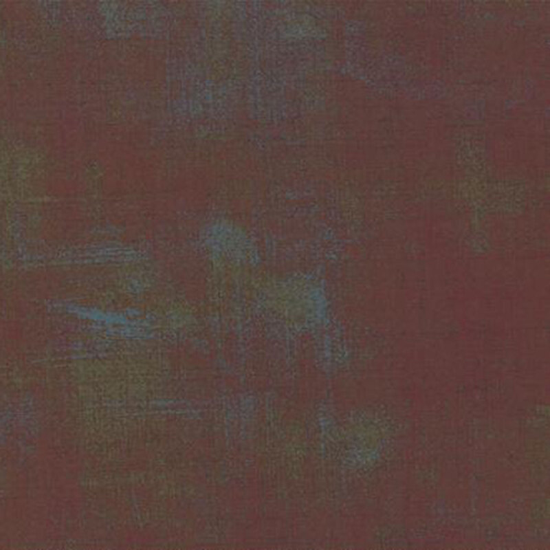 Abstract fabric in shades of dark red, blue, and green with a subtle grunge effect.