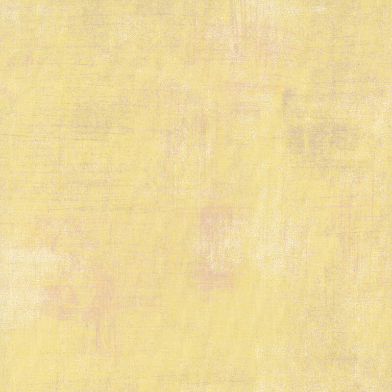 Textured light yellow fabric with subtle variations and a soft, painterly feel.