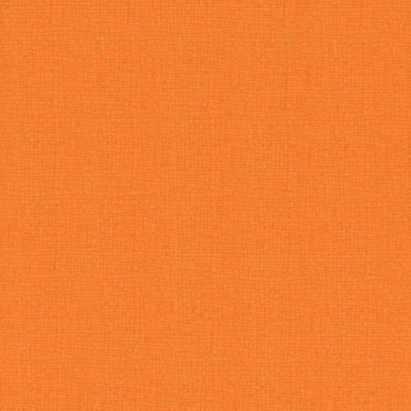 Close-up of a textured fabric in a warm orange color.