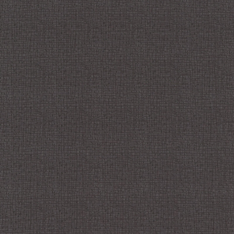 Dark gray textured fabric with a subtle, woven pattern.