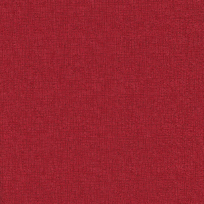 Solid red fabric textured surface with a subtle woven pattern.