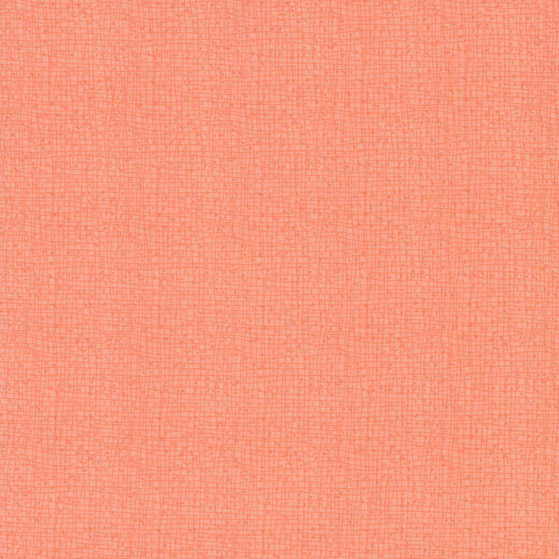 Textured peach fabric with a subtle grid pattern.