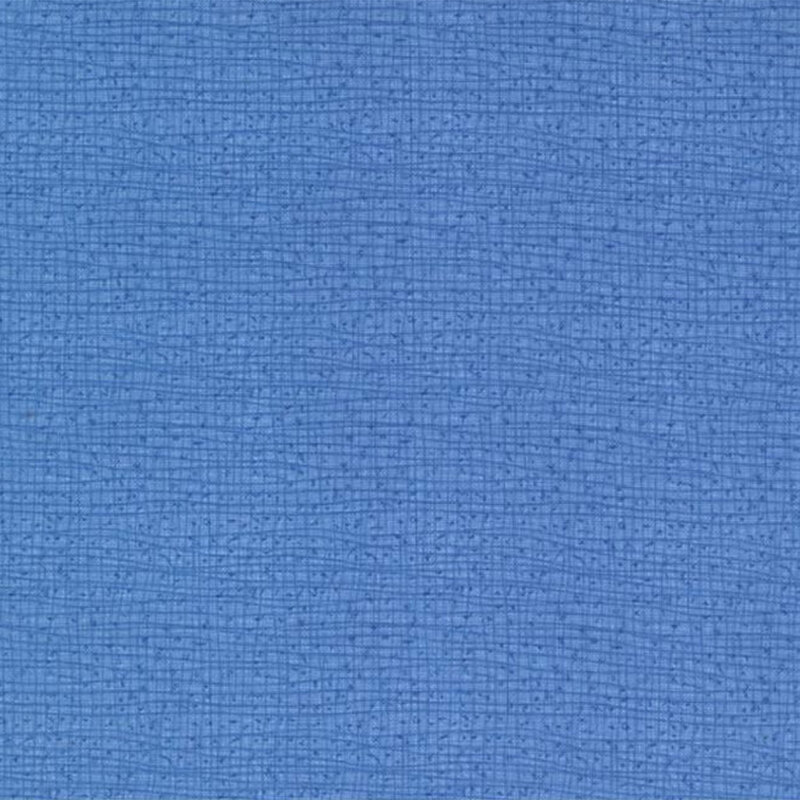 A textured blue fabric background with a woven pattern.