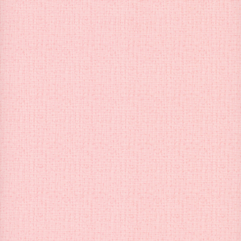 Light pink textured fabric background with a subtle weave pattern.