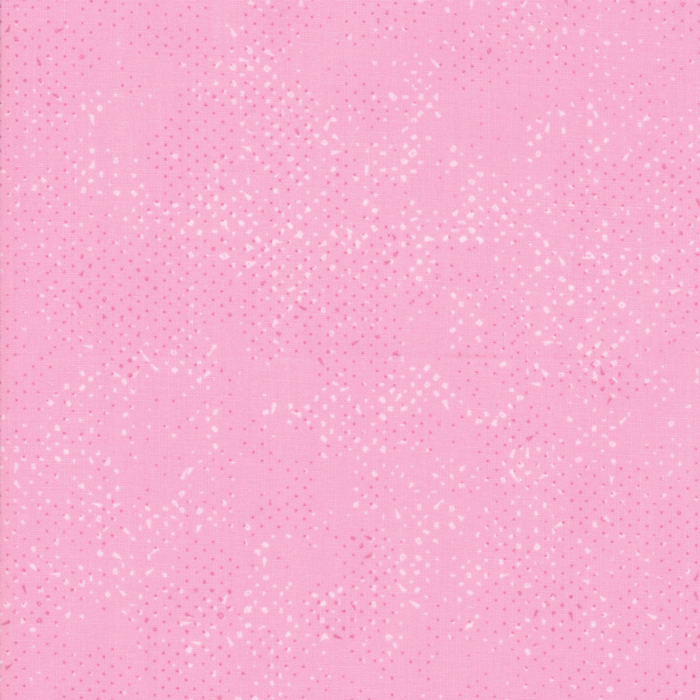 Textured pastel pink fabric with a pattern of small tonal speckles