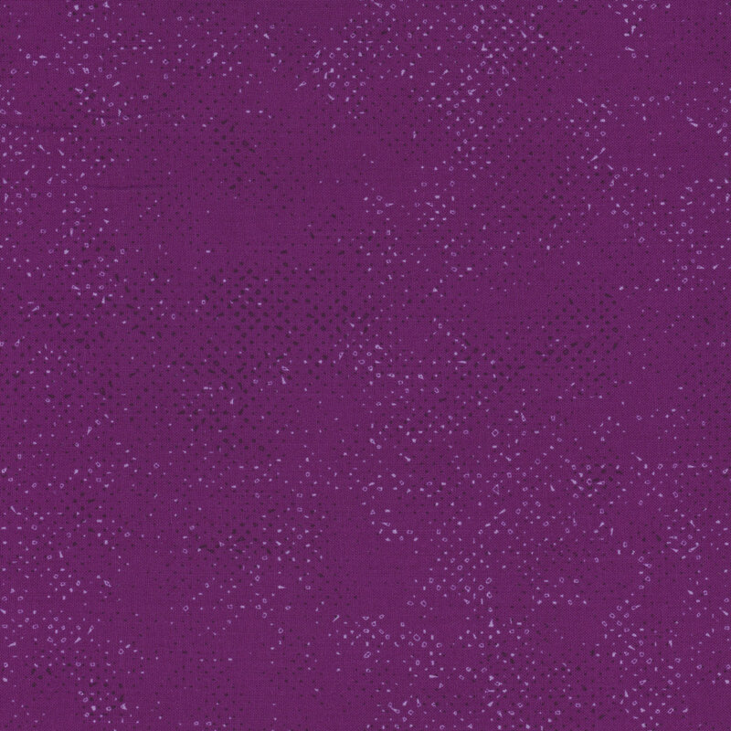 Textured magenta purple fabric with a pattern of small tonal speckles