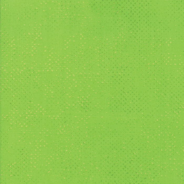 Textured lime green fabric with a pattern of small tonal speckles