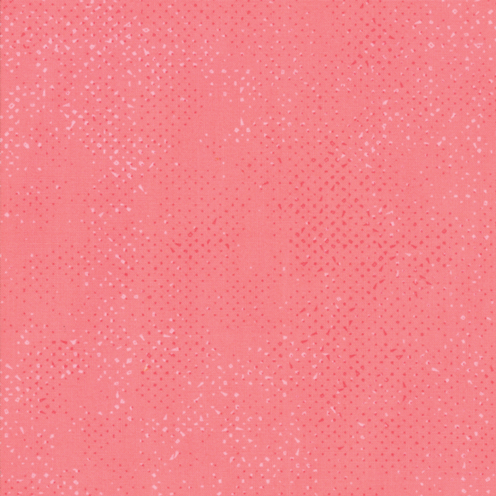 Textured coral pink fabric with a pattern of small tonal speckles