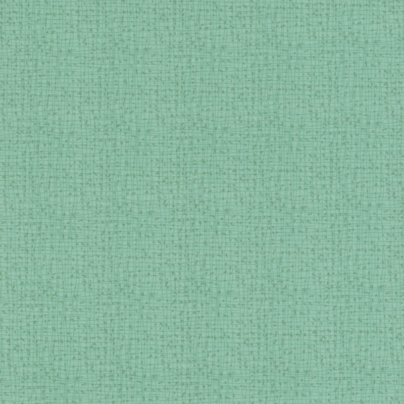 Textured turquoise fabric with a simple, woven pattern.