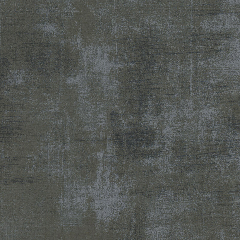 Dark textured fabric with subtle variations in tone and faint streaks.