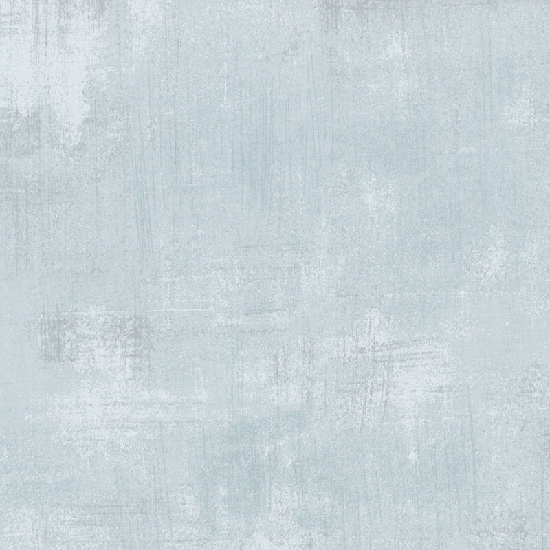 Light blue textured fabric with subtle variations and brushstroke patterns.